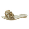 Beige sandal with floral decorations on a white background