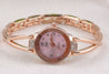Rose gold watch with pink face on a white background